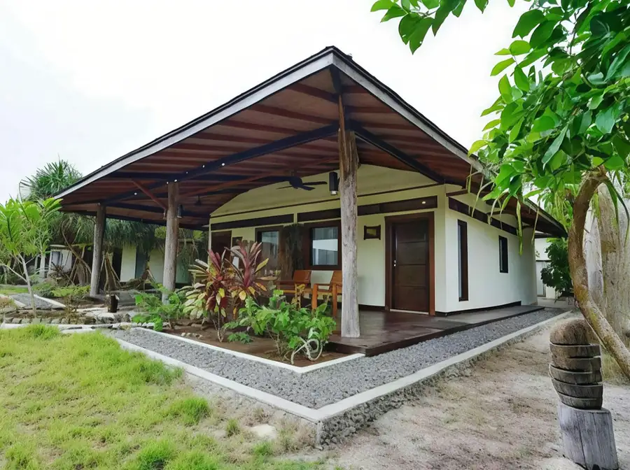 A local style white chalet featuring a corrugated roof at Mussah Poteh Resort