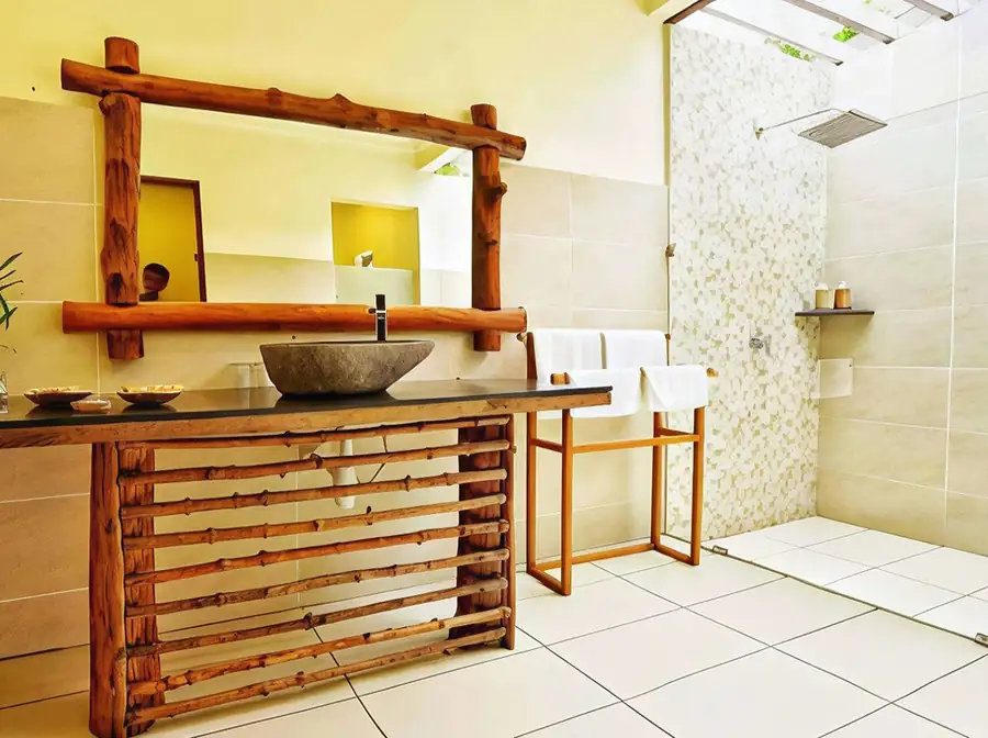 A practical bathroom at Mussah Poteh Resort with shower and vanity