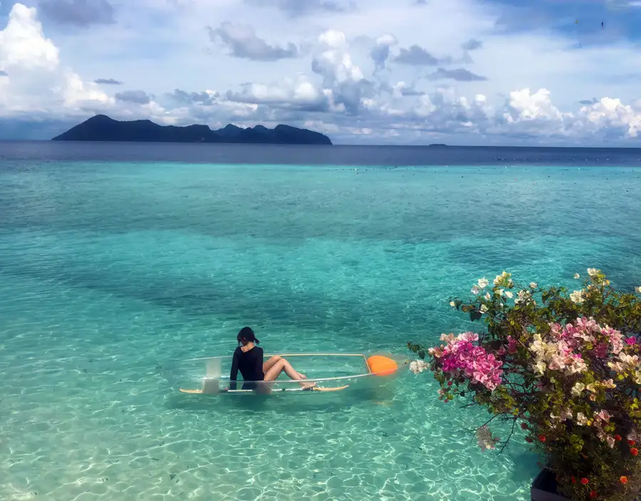 Guest enjoying a kayaking session in the turquoise sea Mussah Poteh Resort
